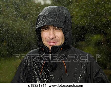 Stock Image - A man getting soaked in the rain. Fotosearch