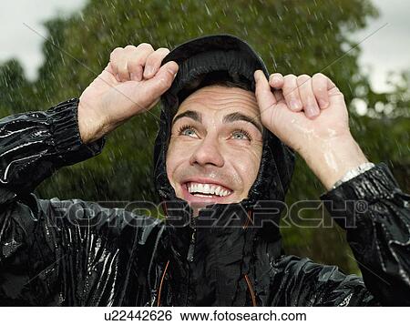 Stock Photograph - A man getting soaked in the rain. Fotosearch