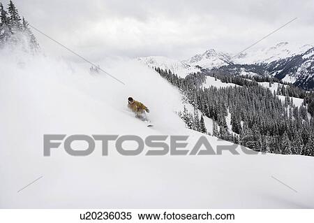 Stock Photography - A man snowboarding. Fotosearch