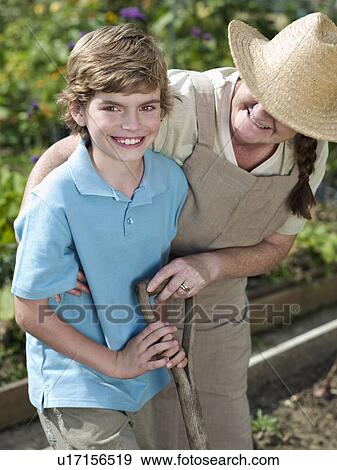A mother and son in a garden View Large Photo Image Stock Photo - A mother and son in a garden. Fotosearch