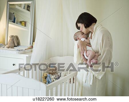 A mother holding a new born baby View Large Photo Image Stock Image - A mother holding a new born baby. Fotosearch