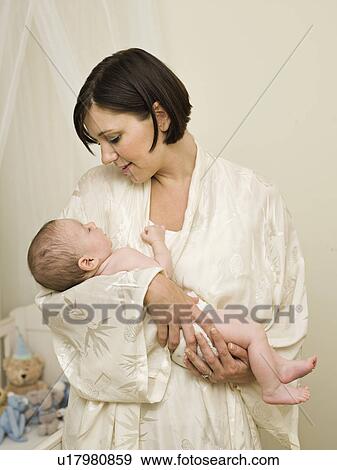 Stock Photo - A mother holding a new born baby. Fotosearch