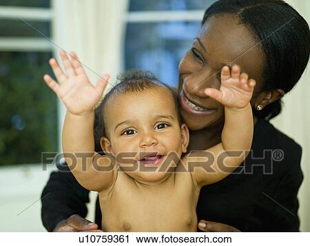 Stock Image - A mother hugging her little baby. Fotosearch