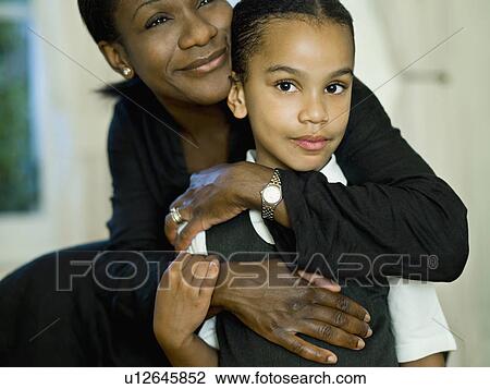 A mother hugging her little girl View Large Photo Image Stock Image - A mother hugging her little girl. Fotosearch