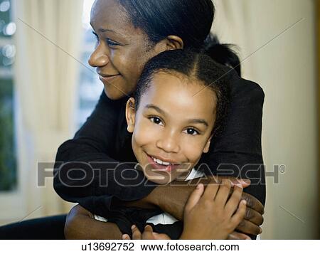 A mother hugging her little girl View Large Photo Image Stock Image - A mother hugging her little girl. Fotosearch