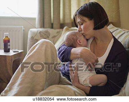 A mother kissing her new baby View Large Photo Image Picture - A mother kissing her new baby. Fotosearch
