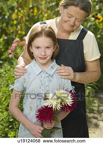 A mother proudly holding her daughter View Large Photo Image Stock Photo - A mother proudly holding her daughter. Fotosearch