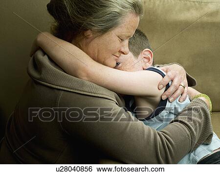 A mum hugging her son View Large Photo Image Stock Photograph - A mum hugging her son. Fotosearch
