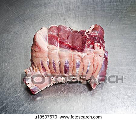 Stock Image - A piece of uncooked tied meat. Fotosearch