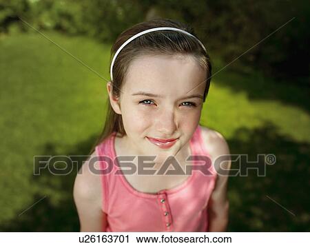 Stock Image - A portrait of a girl in a garden. Fotosearch