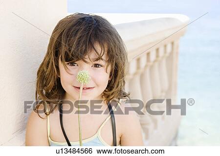 A portrait of a girl with plant stem View Large Photo Image Stock Photograph - A portrait of a girl with plant stem. Fotosearch