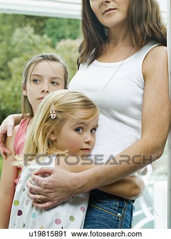 Stock Image - A portrait of a mother and her daughters. Fotosearch