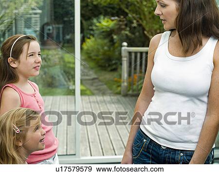 Stock Photo - A portrait of a mother and her daughters. Fotosearch