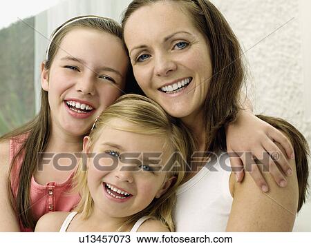 A portrait of a mother and two daughters View Large Photo Image Stock Image - A portrait of a mother and two daughters. Fotosearch