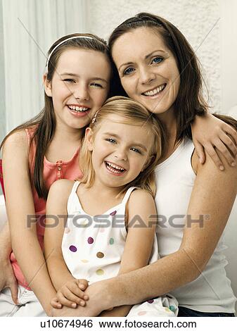 A portrait of a mother and two daughters View Large Photo Image Stock Photograph - A portrait of a mother and two daughters. Fotosearch