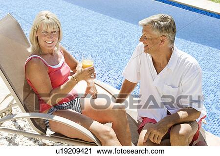 A senior couple by the pool View Large Photo Image Stock Image - A senior couple by the pool. Fotosearch