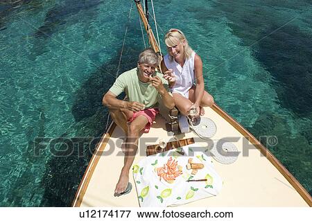 A senior couple picnic while sailing View Large Photo Image Stock Photo - A senior couple picnic while sailing. Fotosearch