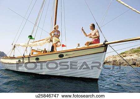 Stock Photo - A senior couple sailing. Fotosearch