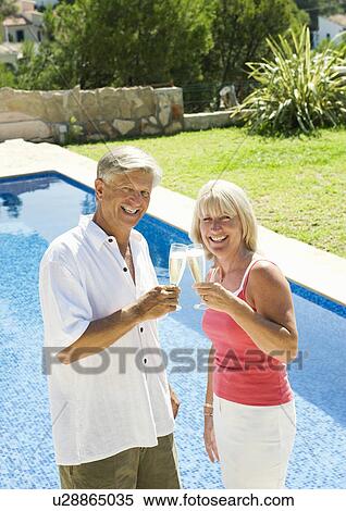 Stock Photography - A senior couple saying cheers. Fotosearch