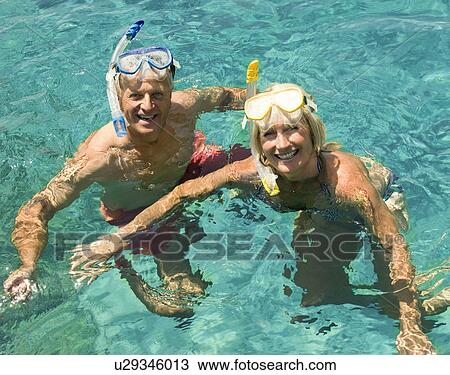 A senior couple swimming with snorkels View Large Photo Image Stock Image - A senior couple swimming with snorkels. Fotosearch
