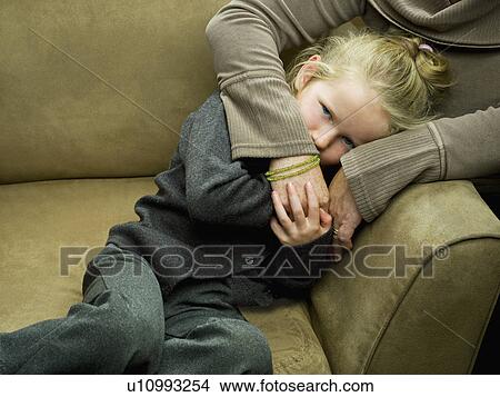 Picture - A shy girl looking straight to camera. Fotosearch
