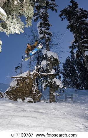 A snowboarder jumping View Large Photo Image Stock Photo - A snowboarder jumping. Fotosearch