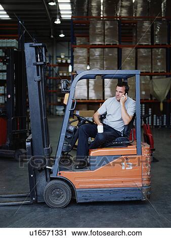 A warehouse manager takes a tea break View Large Photo Image Stock Image - A warehouse manager takes a tea break. Fotosearch