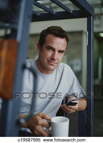 A warehouse manager takes a tea break View Large Photo Image Stock Photography - A warehouse manager takes a tea break. Fotosearch