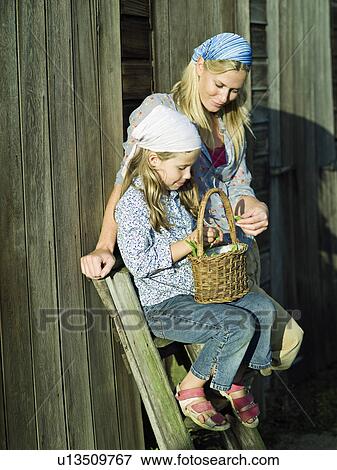 Stock Photo - A woman and girl with a basket of beans. Fotosearch
