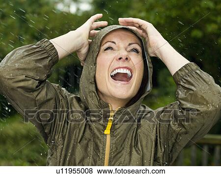 Stock Photo - A woman in the rain smiling. Fotosearch