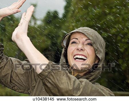 A woman in the rain smiling View Large Photo Image Stock Photography - A woman in the rain smiling. Fotosearch