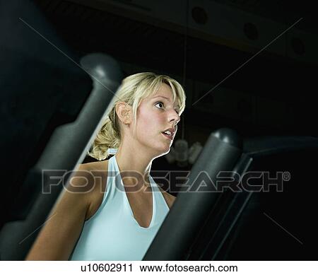 A woman on a running machine View Large Photo Image Stock Image - A woman on a running machine. Fotosearch
