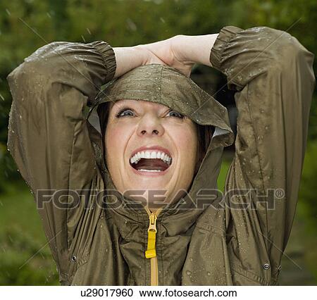 A woman with her arms up in the rain View Large Photo Image Stock Image - A woman with her arms up in the rain. Fotosearch
