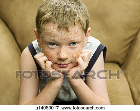 Stock Photo - A young boy looking straight to camera. Fotosearch