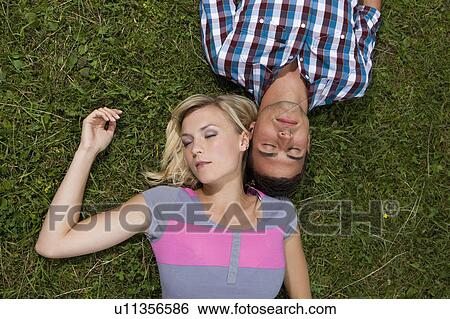 Stock Photograph - A young couple relaxing. Fotosearch