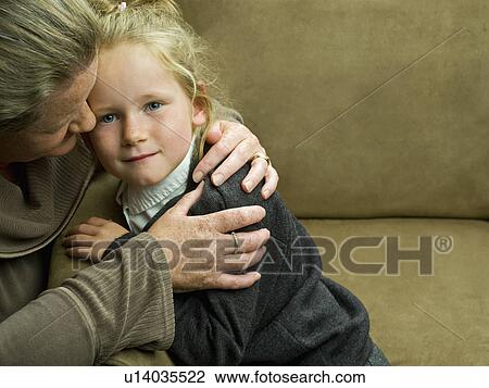A young girl being hugged by her mum View Large Photo Image Stock Image - A young girl being hugged by her mum. Fotosearch