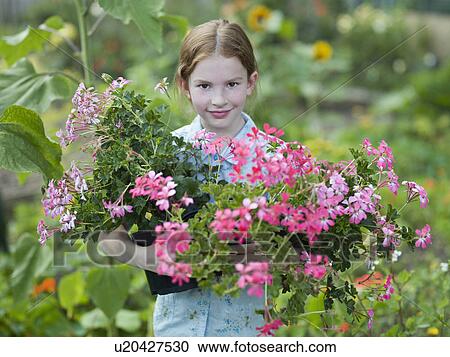 A young girl with flowering pot plants View Large Photo Image Stock Image - A young girl with flowering pot plants. Fotosearch