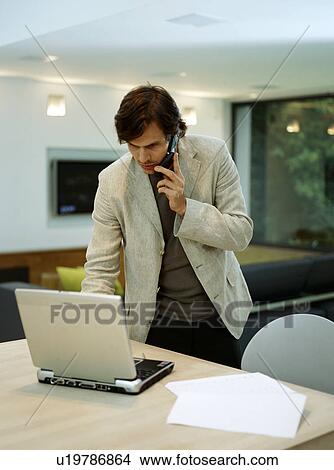 Picture - A young trendy male works from home. Fotosearch