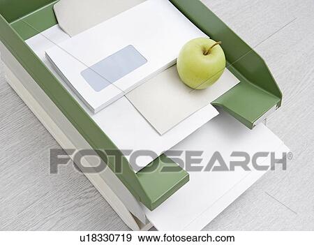 Stock Photo - apple in in-tray. Fotosearch