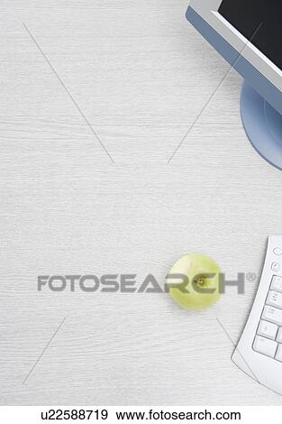 Stock Photo - apple on desk. Fotosearch