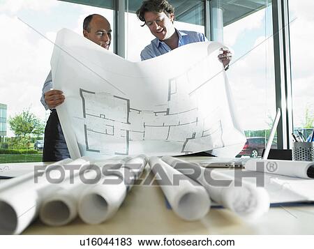 Architects looking at blue prints View Large Photo Image Stock Image - Architects looking at blue prints. Fotosearch