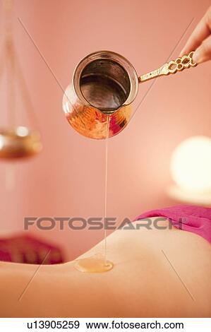 Ayurvedic oil dropping on body View Large Photo Image Stock Photo - Ayurvedic oil dropping on body. Fotosearch