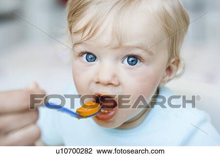 baby being fed looking at viewer View Large Photo Image Stock Image - baby being fed looking at viewer. Fotosearch