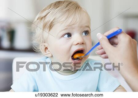 baby being fed View Large Photo Image Stock Image - baby being fed. Fotosearch