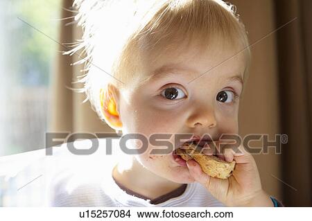 Baby boy eating a slice of bread View Large Photo Image Picture - Baby boy eating a slice of bread. Fotosearch