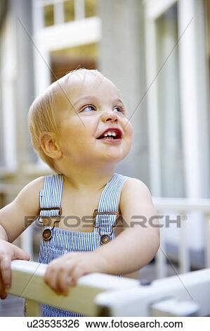 Stock Photograph - Baby boy in his playpen. Fotosearch