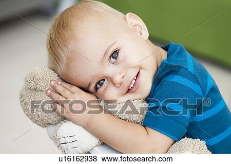 baby cuddling teddy bear View Large Photo Image Stock Photo - baby cuddling teddy bear. Fotosearch
