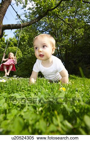 Baby in the garden, girl on the swing View Large Photo Image Stock Photography - Baby in the garden, girl on the swing. Fotosearch