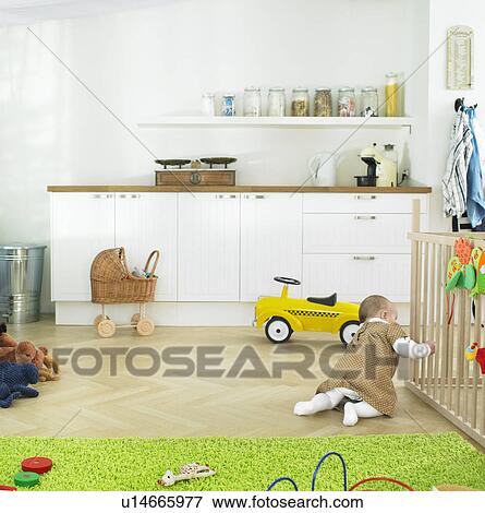 Stock Photo - baby playing alone. Fotosearch