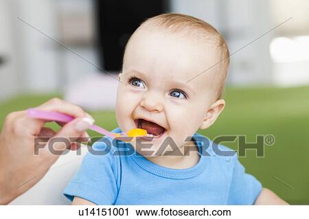 baby sitting in chair being fed View Large Photo Image Stock Image - baby sitting in chair being fed. Fotosearch